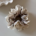 Detailed macro view of French style floral hair scrunchie with delicate lace trim edges - Pink Floral Lace Scrunchie
