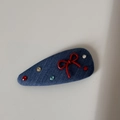 Close-up of denim blue hair clip with a red bow and five sparkling colorful rhinestones - Dark Denim - Red Bow Snap Clip
