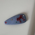 Close-up of blue fabric BB clip with a red 3D bow and colorful sparkling rhinestones - Light Denim - Red Bow Snap Clip