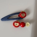 Detail view of denim blue heart and red apple hair clips set with yellow button accents - Dark Denim - Apple Pair Clips
