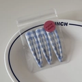 Detailed view of three blue checkered snap hair clips in elegant minimalist packaging - Blue Bold Gingham Style