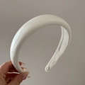 Detail of white glossy patent leather padded headband with reflective smooth finish - Off-white