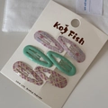 Detail of 6-piece hair clip set featuring pink floral and wavy patterns on display card - Pink & Green
