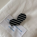 Gros plan d'une pince à cheveux en forme de cœur avec des rayures noires et blanches - Black White Striped Heart Style
