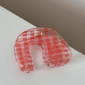 Detailed close-up of red plaid checkered hair claw clip with metal spring mechanism - Horseshoe Shape