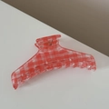 Detailed view of large red and white checkered hair claw clip with transparent resin finish - Hanger Shape Style