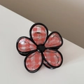 Detail view of flower-shaped hair claw clip with red and white gingham pattern and black trim - Flower Shape