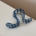 Detail view of the S-shaped blue checkered hair claw clip with a strong golden spring - Wavy S-Curve Style / Dark Blue Plaid