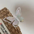 Detailed close-up of a butterfly hair clip with pink and blue iridescent acetate texture - Blue & Pink