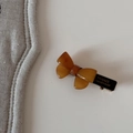 Detailed view of handmade amber acetate bow hair clip with gold France branding - Bobby Pin / Brown