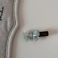Detail view of acetate bow hair clip featuring marble texture and gold lettering - Bobby Pin / Green/White
