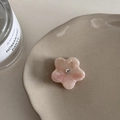 Detailed macro view of a pink marble floral acetate hair clip with a sparkling center rhinestone - Sakura Pink