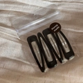Close-up of 4-piece set of black glossy BB hair clips in branded Hansy Made packaging - Black
