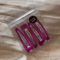 Detailed view of four purple glossy teardrop BB hair clips in simple bag packaging - Rose Red