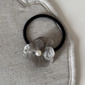 Detailed macro shot of a gray acetate flower hair clip with pearl and rhinestones decoration - Rhinestone Pearl Flower (FJ891537) / Gray Hair Tie