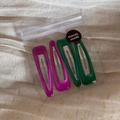Set of four glossy teardrop hair clips in purple and green within a transparent zipper bag - Green Rose Red