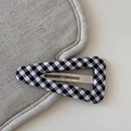 Detail shot of a Gingham fabric wrapped triangle BB hair clip with silver metal snap - Plaid Triangle BB-Black White