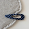 Detailed view of the checkered fabric wrap and silver metal spring on a navy blue BB hair clip - Plaid Waterdrop BB-Blue Black