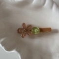 Macro detail of candy-colored flower hair clip with sparkling glitter and green bead - Light Coffee