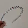 Detail view of wavy metal headband with colorful rhinestones for hair styling - Gray