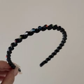Detail of a wavy black headband featuring colorful rhinestones for hair styling - Black
