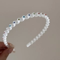 Detail view of wave shaped plastic headband with colorful rhinestones for hair styling - Frosted White