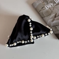 Close-up of black satin hair claw clip with faux pearl embellishments and bow detail - Pearl Triangle Claw-Black