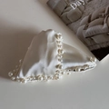 Detail of elegant cream satin heart hair claw clip with faux pearl trim on white backdrop - Pearl Triangle Claw-Beige