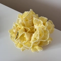Detail of yellow polka dot organza scrunchie with layered ruffles and white wave edges - Yellow
