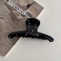 Detailed view of a black acetate hair claw clip decorated with multi-colored rhinestones - Black