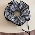 Detail of black and white plaid scrunchie featuring frill edges and long ribbon streamers - Black Plaid Ribbon Scrunchie