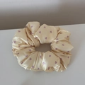 Detailed view of cream satin scrunchie with purple heart patterns and smooth texture - Large Heart Yellow