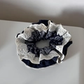 Detailed view of navy blue paisley scrunchie featuring elegant white lace embroidery - Navy Blue Paisley Lace Scrunchie