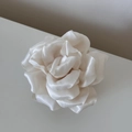 Macro shot of a cream white silk satin rose hair clip with elegant layered petals - Cream White