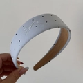 Close-up of light blue polka dot headband with white embroidered bow and suede lining - Embroidered Bow Polka Dot Hairband - Blue