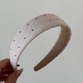 Close-up of beige polka dot hairband featuring exquisite white bow embroidery details - Embroidered Bow Polka Dot Hairband - Pink