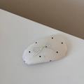 Detailed close-up of a white polka dot hair clip with beige embroidered bow detail - Embroidered Bow Polka Dot Hair Clip - Off-White
