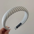Close-up of black and white striped sponge headband featuring a Hand Made woven label - Padded Headband / Black & White Stripes