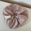 Close-up of pink and white gingham scrunchie featuring a handmade woven label detail - Scrunchie / Pink Plaid