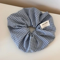 Dettaglio di un elastico a quadretti blu e bianchi con etichetta hand made sul tessuto - Scrunchie / Quadri Blu Chiaro