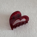 Detailed view of a transparent red heart-shaped hair claw clip on white fabric - Heart (6.5cm)