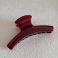 Close-up of a translucent dark red hair claw clip with a glossy finish and metal spring - Thick Straight (11.5cm)