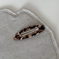 Detailed macro view of the brown leopard print hair clip on a heart-shaped fabric base - Beige Coffee Leopard - Hollow Oval Clip