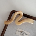 Macro detail of wave shaped hair claw clip with yellow amber texture on linen background - Amber Wave Style / 13cm