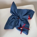 Close-up of blue denim scrunchie with red polka dot lining and a pearl ribbon charm - Denim Red Polka Dot - Scarf Scrunchie