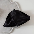 Detail of elegant black satin hair claw with embossed rose pattern on grey fabric texture - Rose Embossed Triangular Claw Clip (FJ892473) / Black
