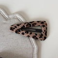 Close-up detail of leopard print fabric hair clip with soft texture on a white surface - Leopard Triangle BB Clip