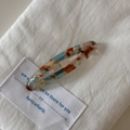 Detailed macro view of the marble pattern acetate hair clip with metal spring barrette - Rainbow