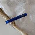 Close-up of handmade dark blue acetate hair clip with gold France lettering and metal spring - Blue