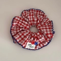 Detail of red checkered scrunchie with blue wavy lace, white label and colorful buttons - Button Decoration Style / Red And White Plaid Scrunchie